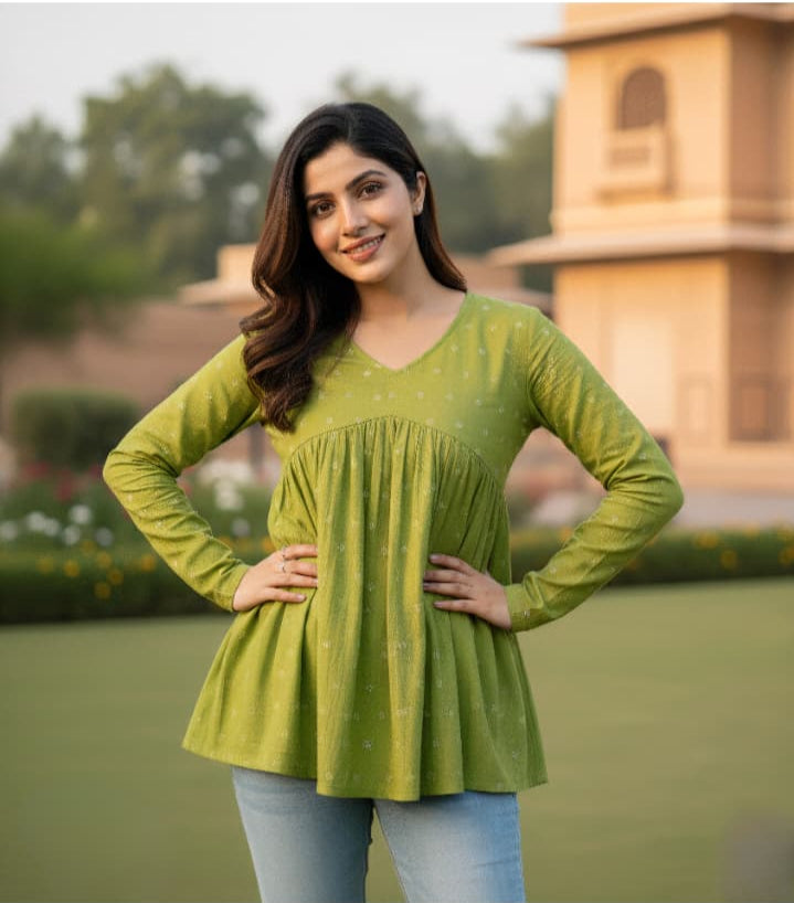Woman wearing a green top with a blurred background